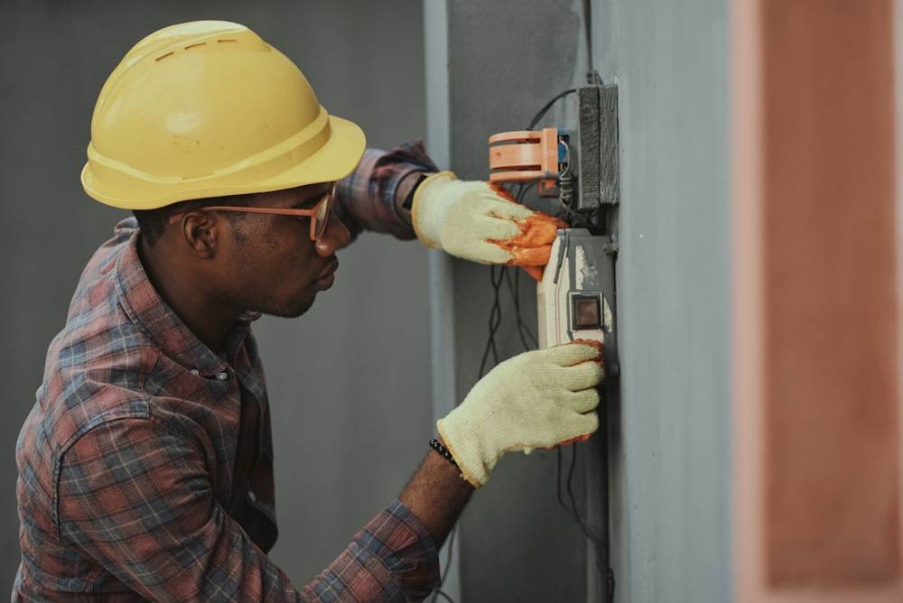 An electrician working on a panel